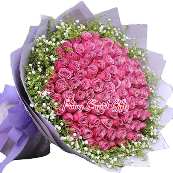 99 Imported Purple Roses in a bouquet arrangement