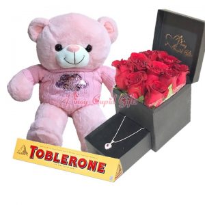 roses in romantic box with necklace, chocolate and teddy bear