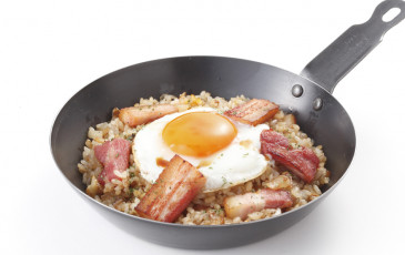 An extravagant fried rice dish with thick smoked bacon.